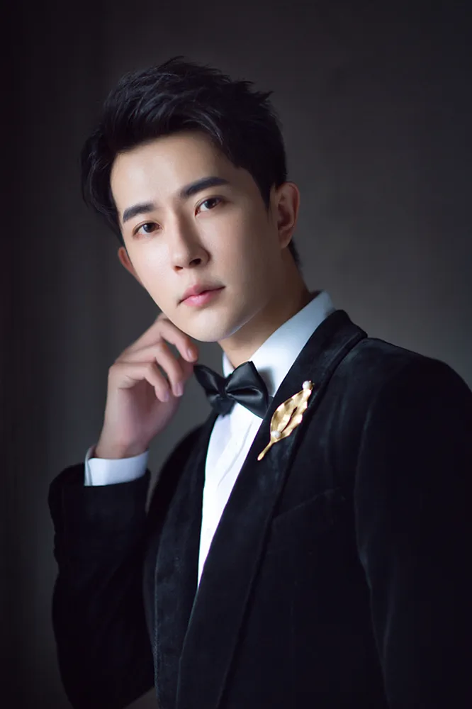 Meng-long Yu black suit with matching bow tie. JPG