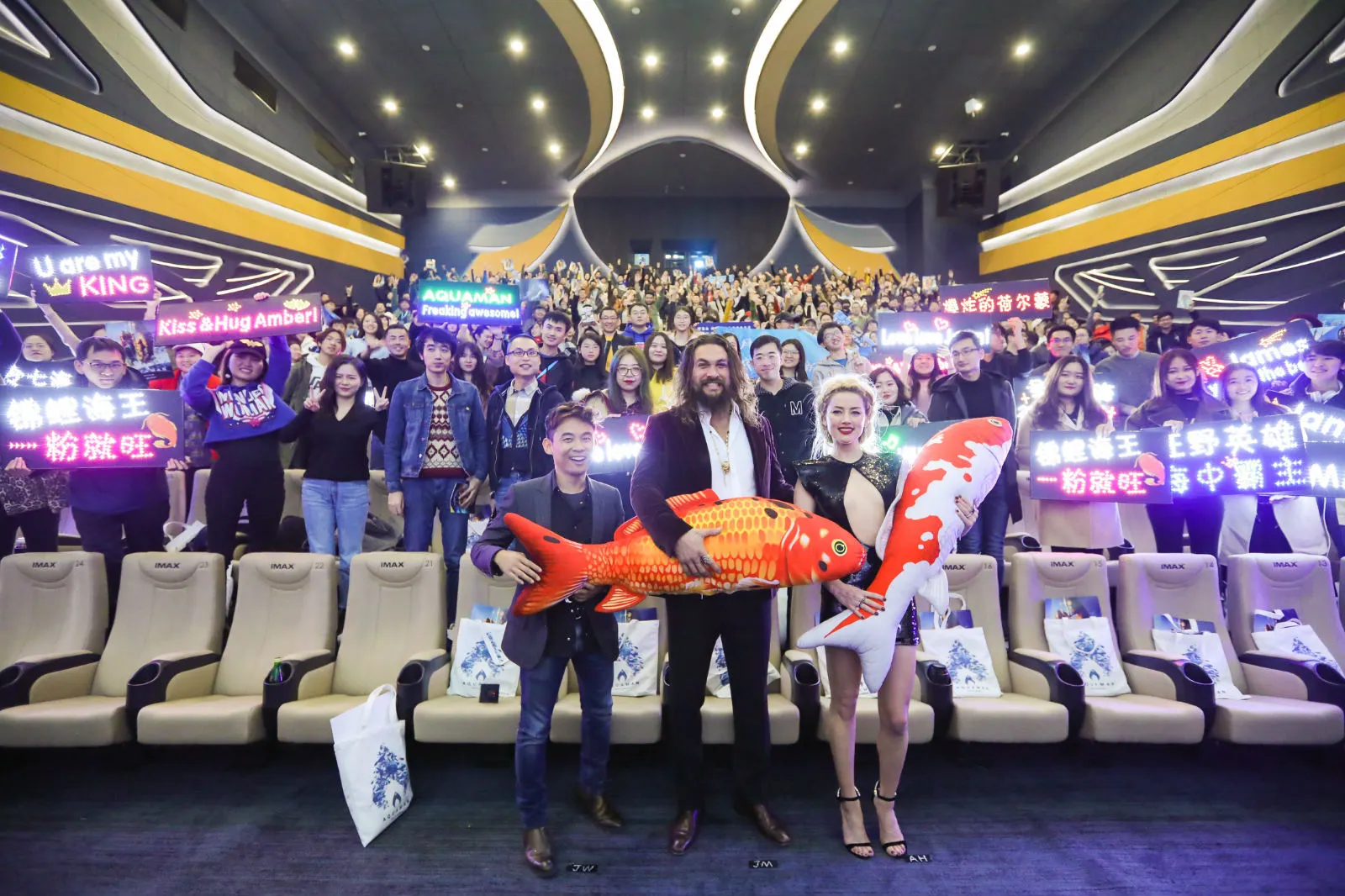 James Wan, Jason and amber cuddle giant koi with fans. JPG